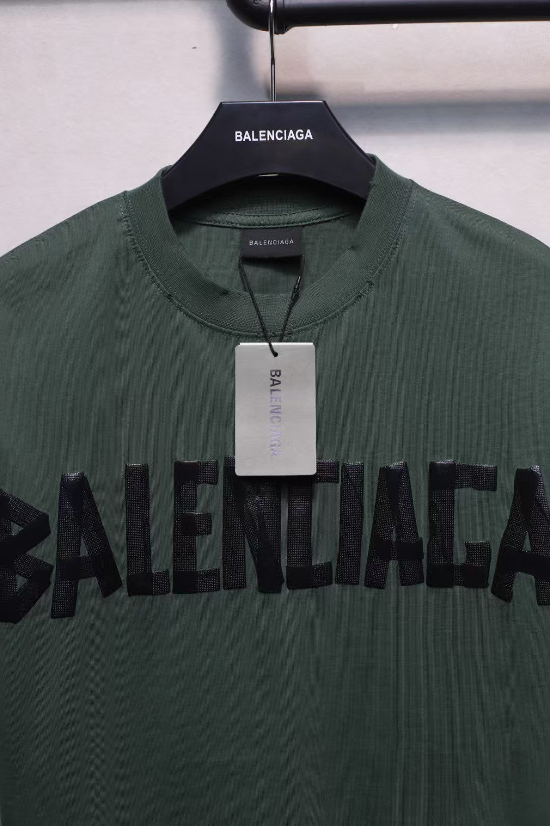 Short sleeved T-shirt with embossed paper tape