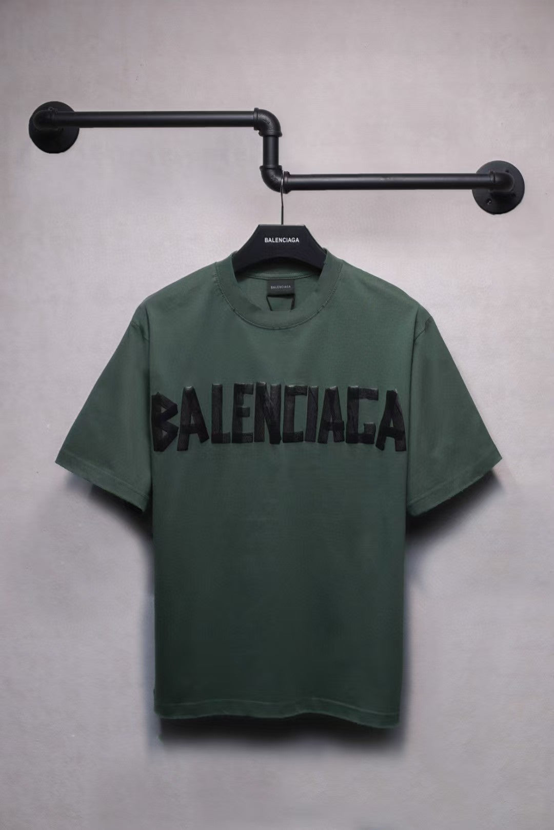 Short sleeved T-shirt with embossed paper tape