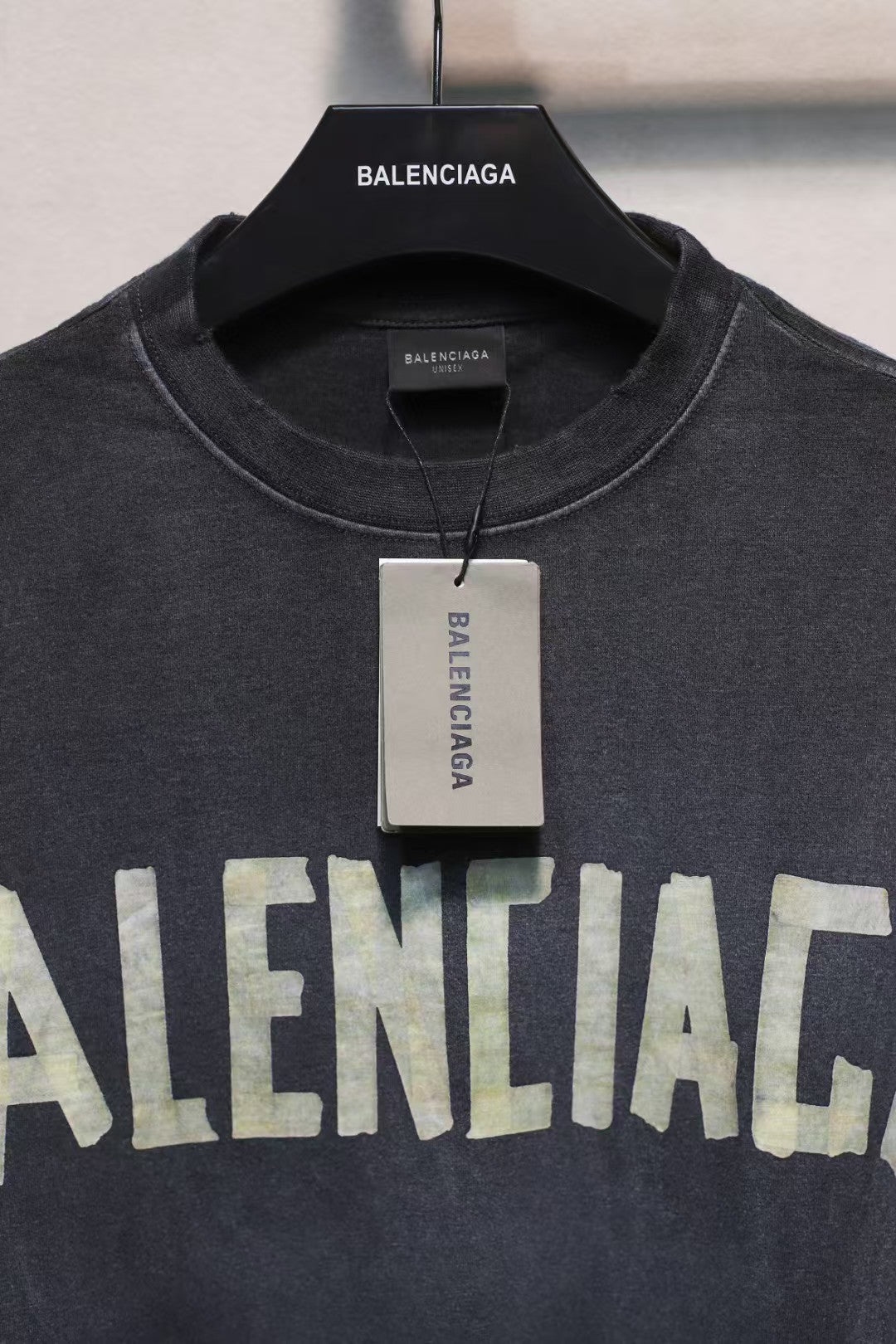Short sleeved T-shirt with embossed paper tape