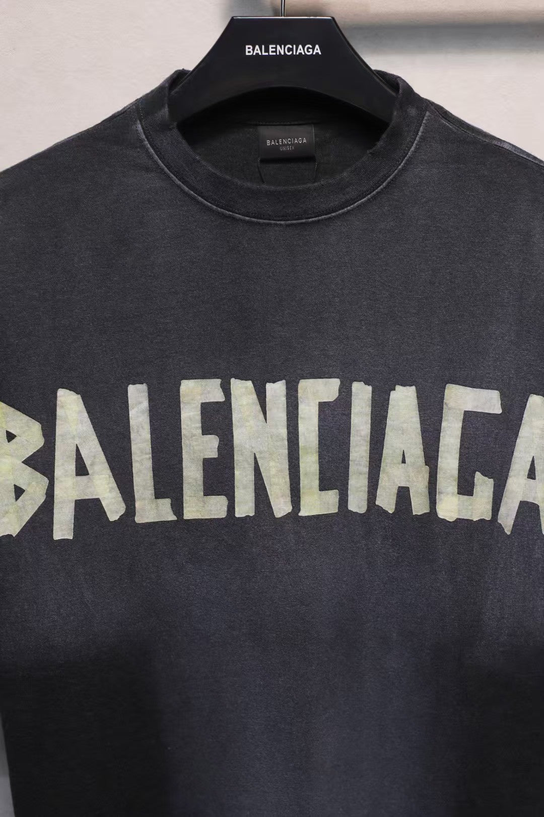 Short sleeved T-shirt with embossed paper tape