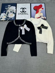 Short knit long sleeved cardigan
