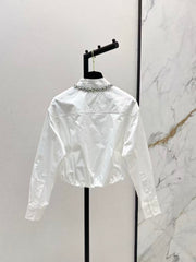 The new heavyweight is a short white shirt decorated with rhinestones