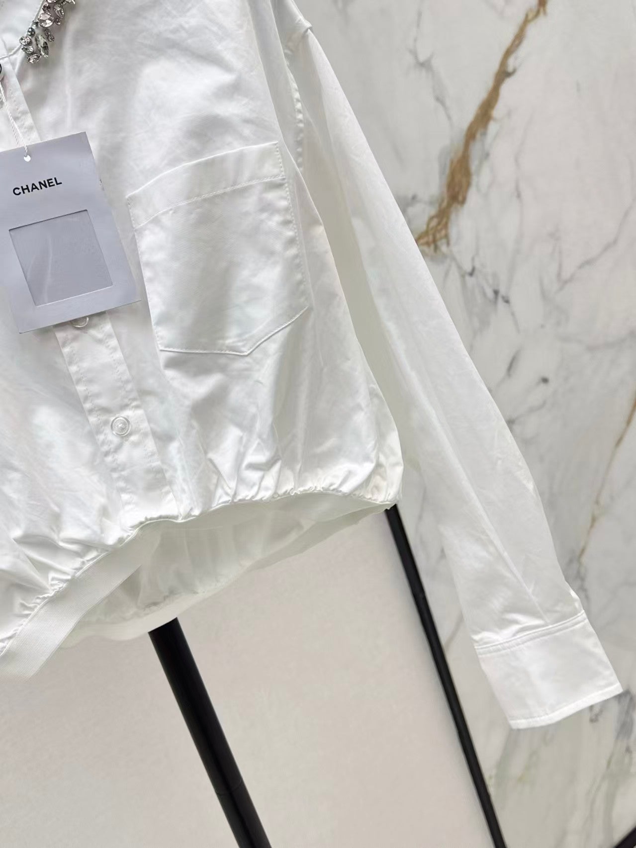 The new heavyweight is a short white shirt decorated with rhinestones