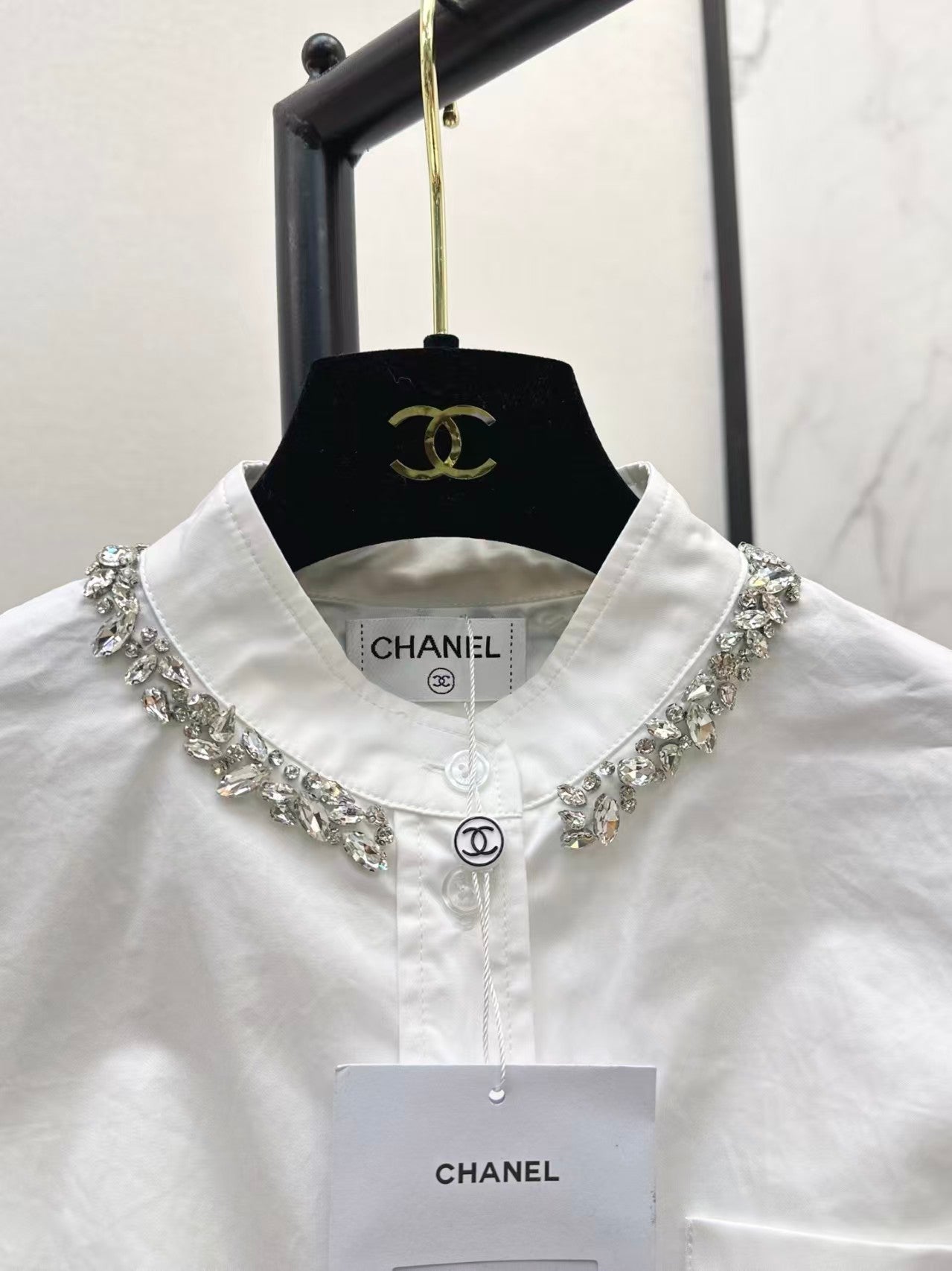 The new heavyweight is a short white shirt decorated with rhinestones