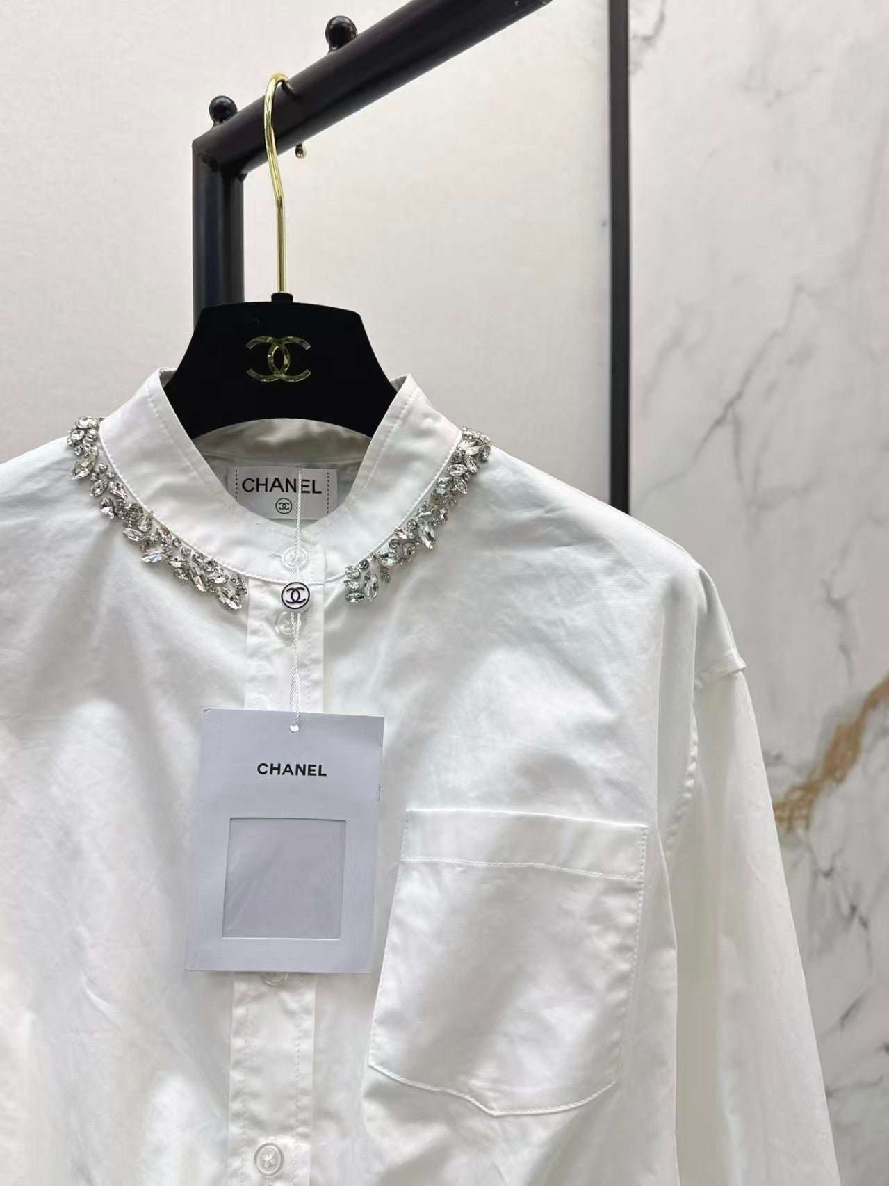 The new heavyweight is a short white shirt decorated with rhinestones