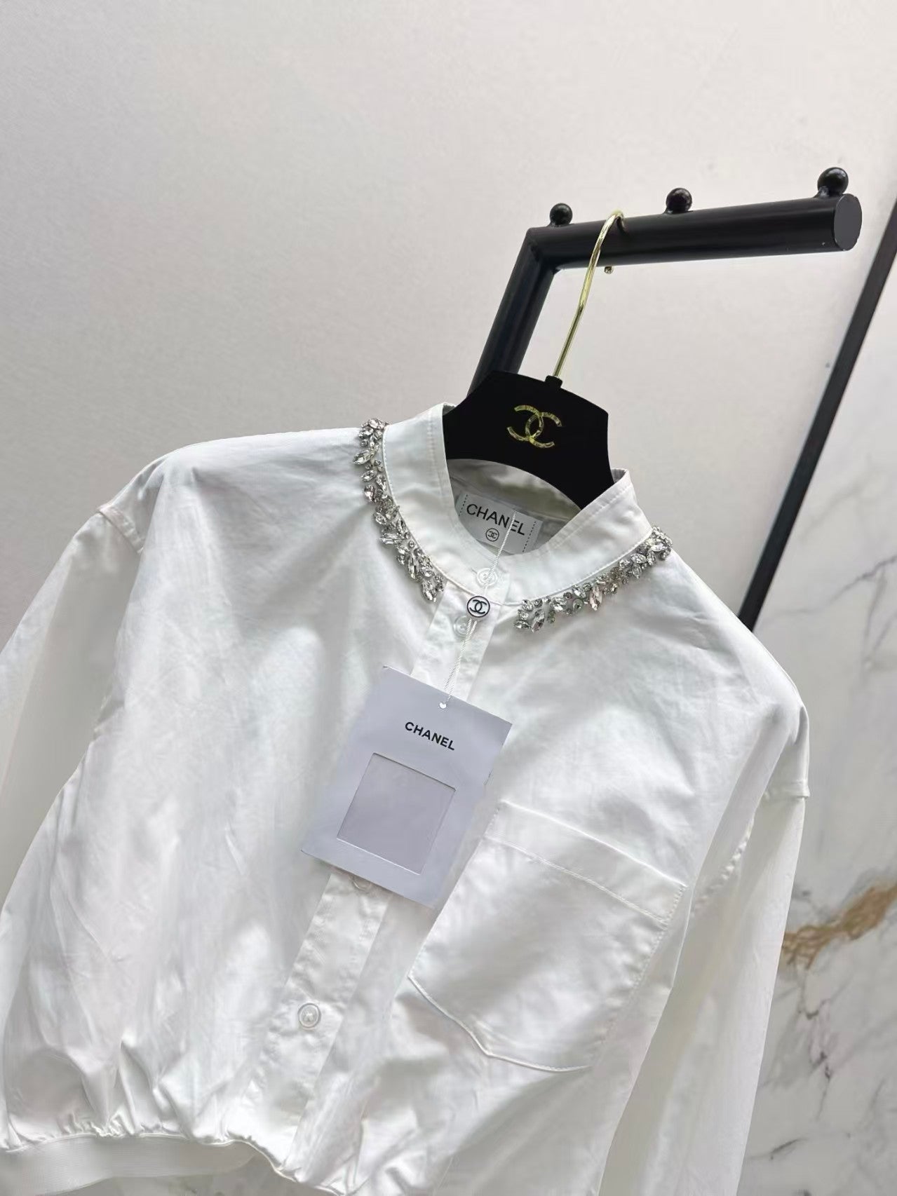 The new heavyweight is a short white shirt decorated with rhinestones
