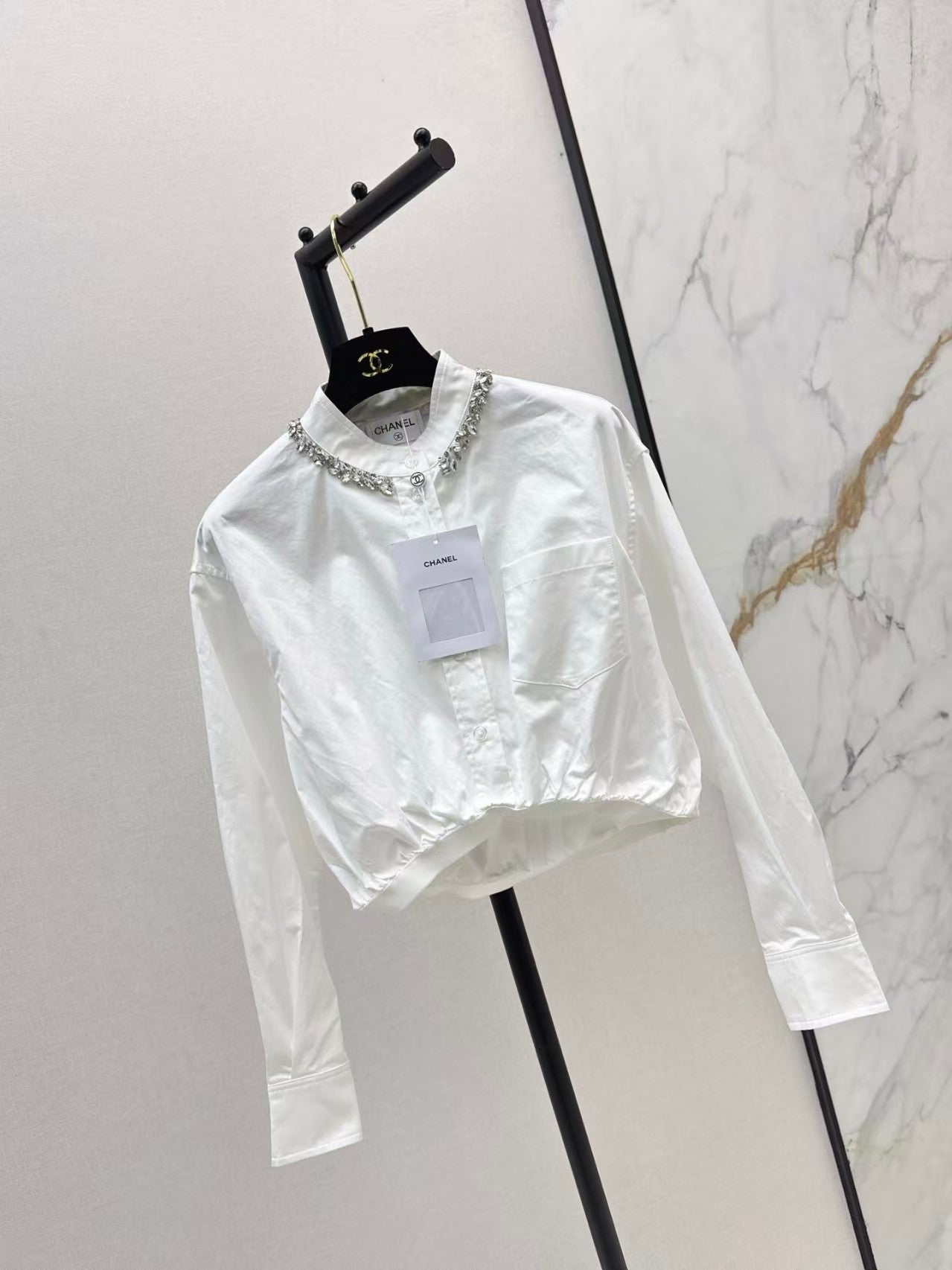 The new heavyweight is a short white shirt decorated with rhinestones