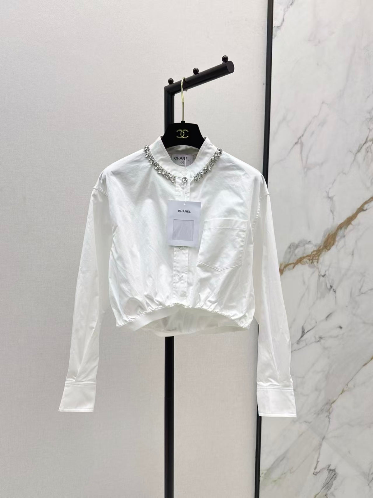 The new heavyweight is a short white shirt decorated with rhinestones