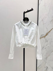 The new heavyweight is a short white shirt decorated with rhinestones