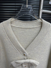 Gentle knitted cardigan with bow tie